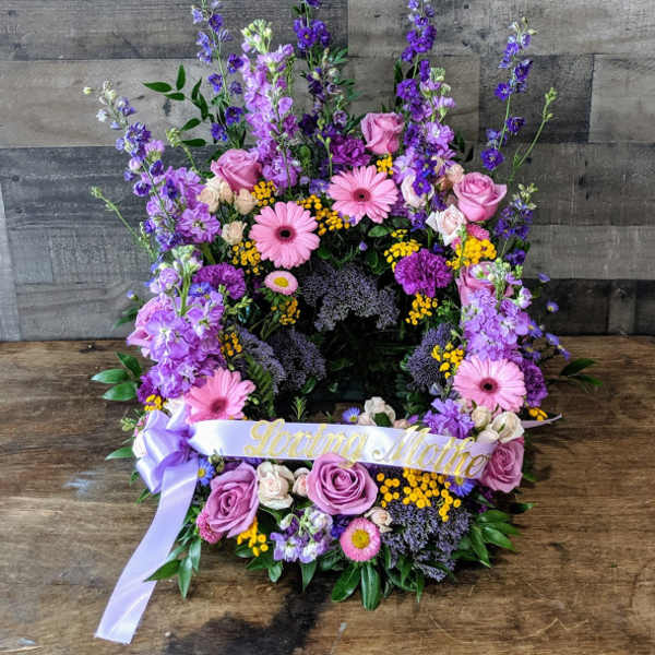 Tall purple and pink floral wreath with Loving Mother ribbon