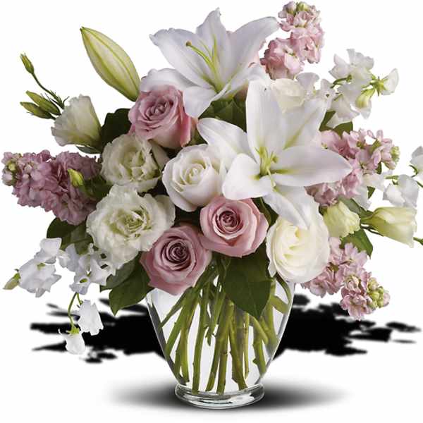 Pink and white bouquet with lilies and roses in a clear glass vase