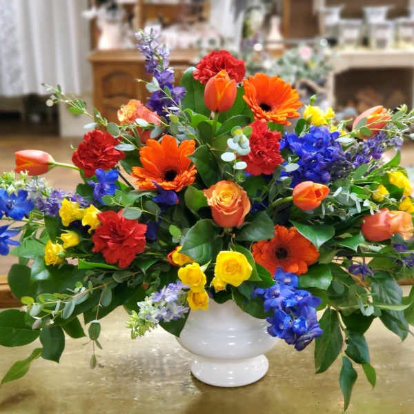 Colorful mixed flower arrangement in a white vase