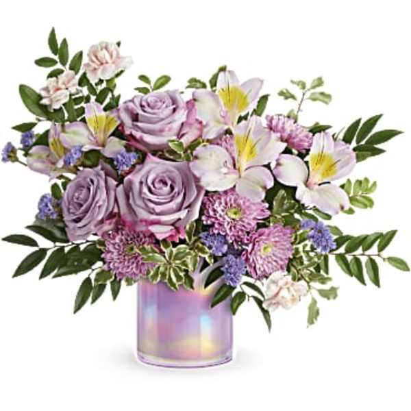 Lavender roses and mixed blooms in an iridescent vase