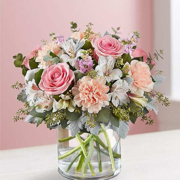 Pink and peach bouquet in a clear glass vase