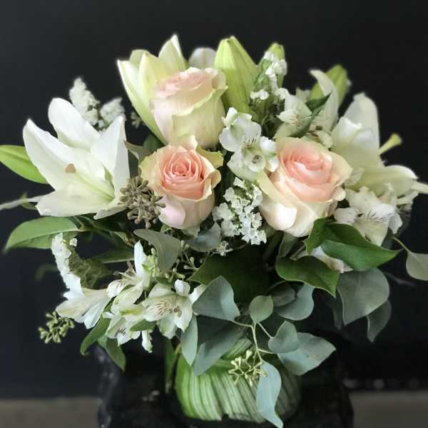 Bouquet of pale pink roses and white lilies with greenery