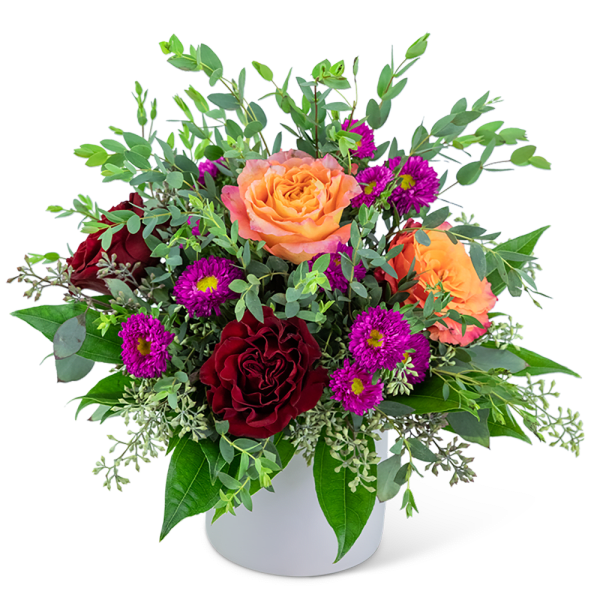 Bouquet of orange and red roses with purple daisies in a white vase