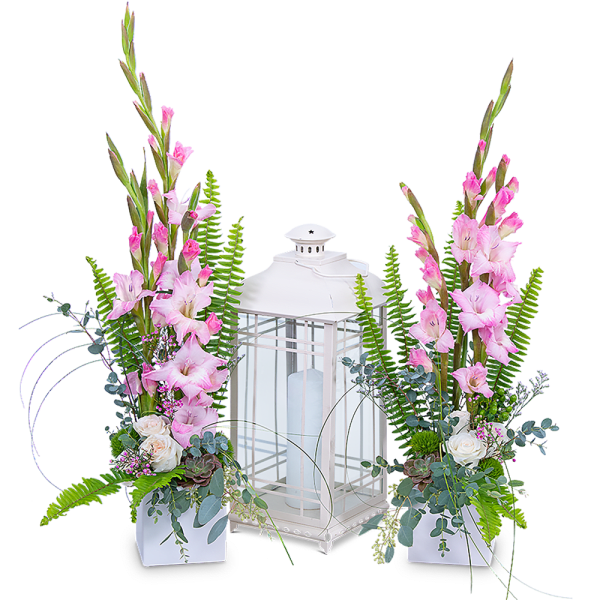 Pink gladiolus arrangements flanking a white lantern centerpiece
