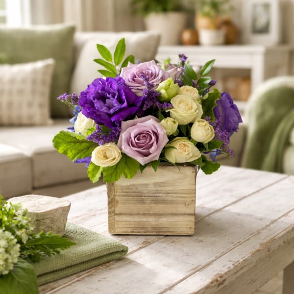 Purple and lavender roses arranged in a wooden box