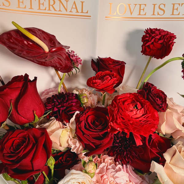 Bouquet of red and blush flowers with an anthurium bloom