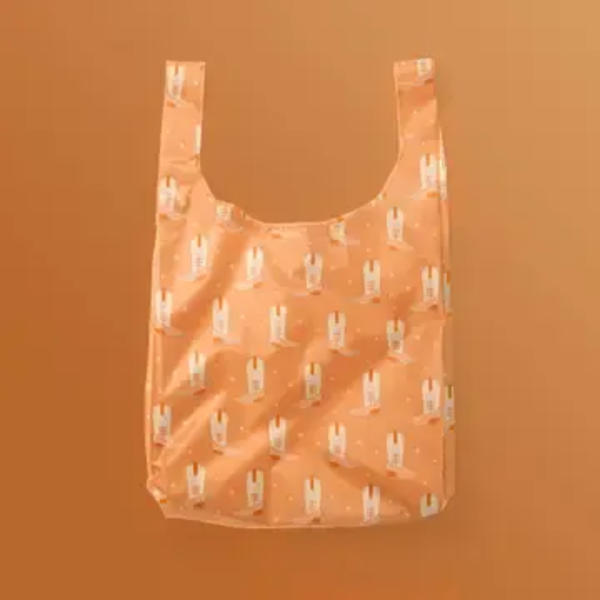 Peach reusable tote bag with a small repeating print