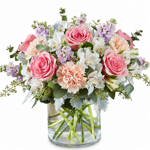 Pink roses and peach carnations in a clear glass vase