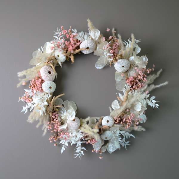 Circular floral wreath with pale pink and white dried flowers