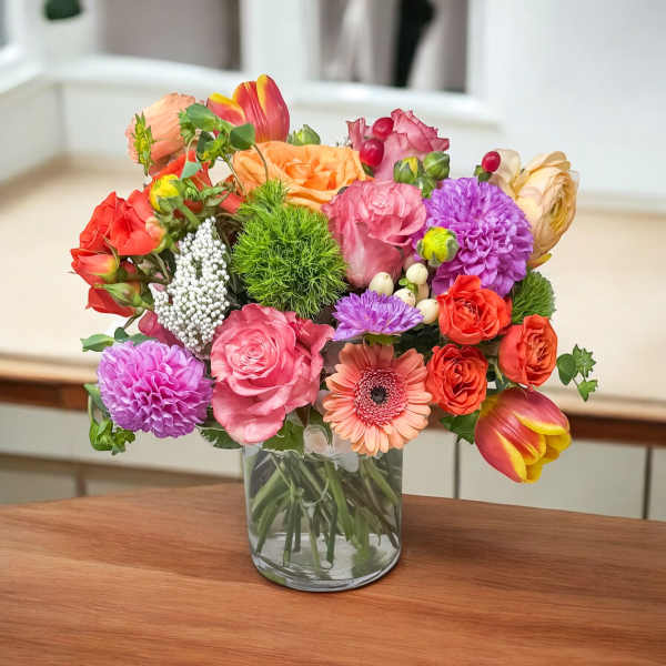 Colorful mixed bouquet in a clear glass vase
