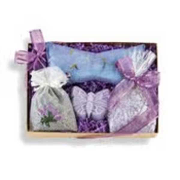 Wooden gift tray with lavender sachet bags, blue eye pillow, and a purple butterfly-shaped soap.