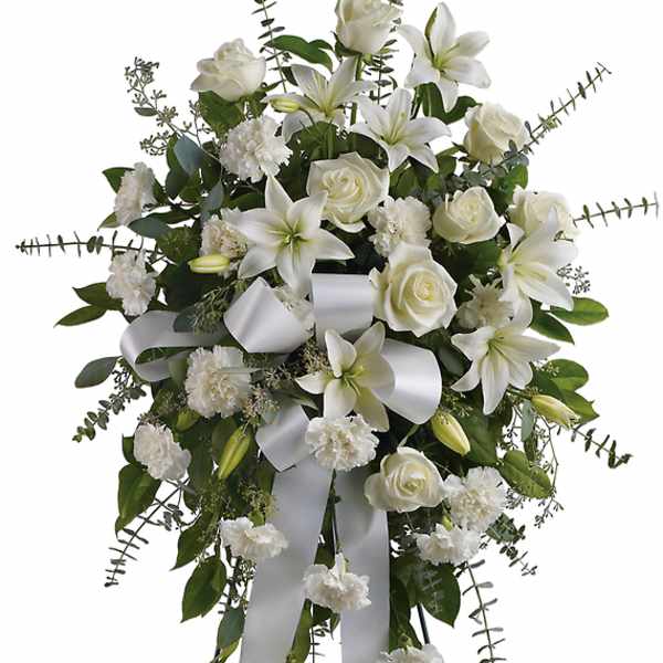 White floral standing spray on an easel with ribbon