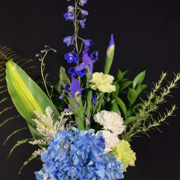 Blue hydrangea bouquet with purple iris and white carnations