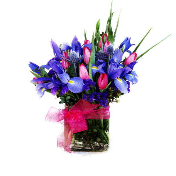 Blue and pink mixed flowers in a glass vase with a pink ribbon