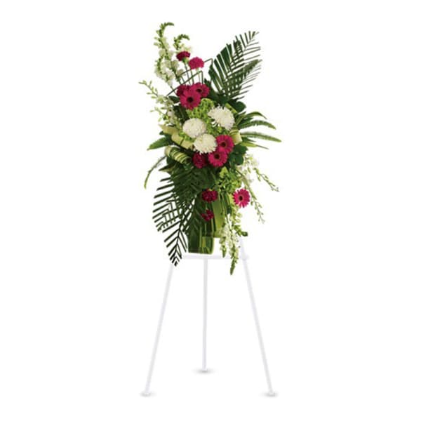 Tall floral standing spray with pink and white blooms on an easel