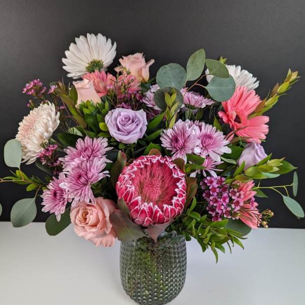 Pink and white mixed bouquet in a textured glass vase