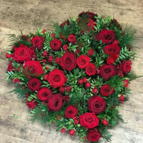 Heart-shaped bouquet of red roses with green filler