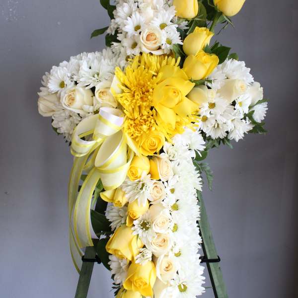 Yellow and white floral standing spray on an easel