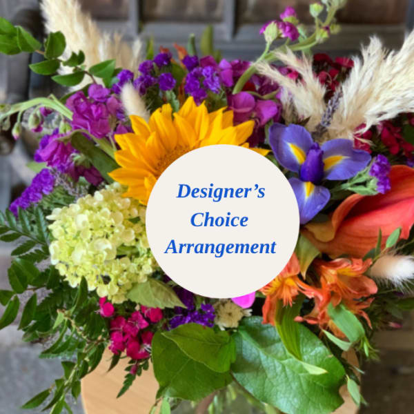 Colorful mixed bouquet with a sunflower, calla lilies, and purple blooms