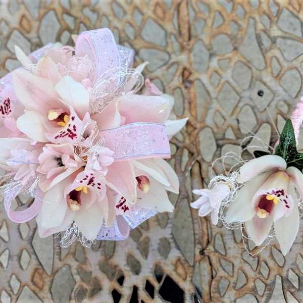 Pink and white orchid corsage and boutonniere with ribbon