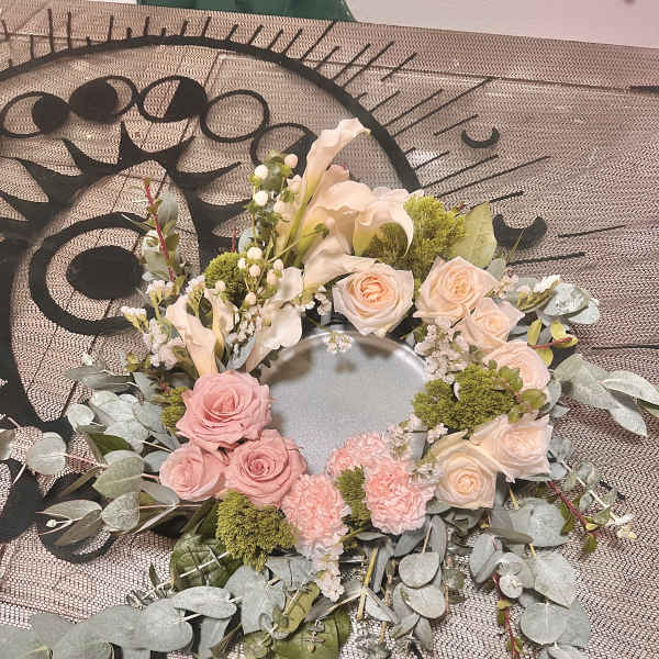 Circular floral wreath with pink and cream roses and calla lilies