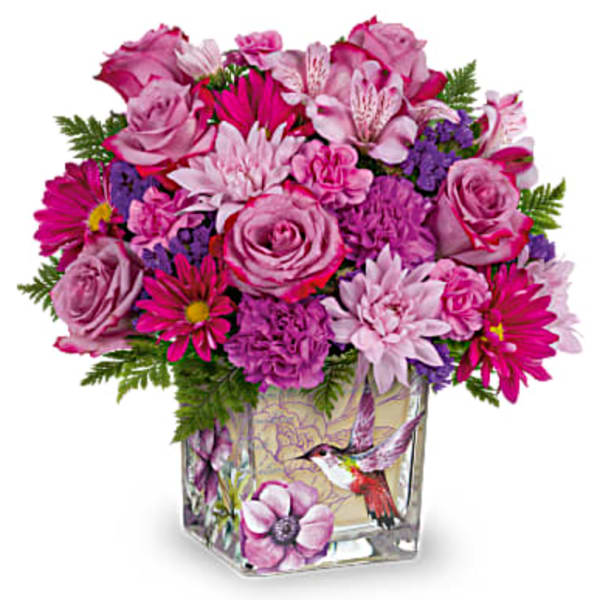 Pink and purple mixed bouquet in a decorated glass vase