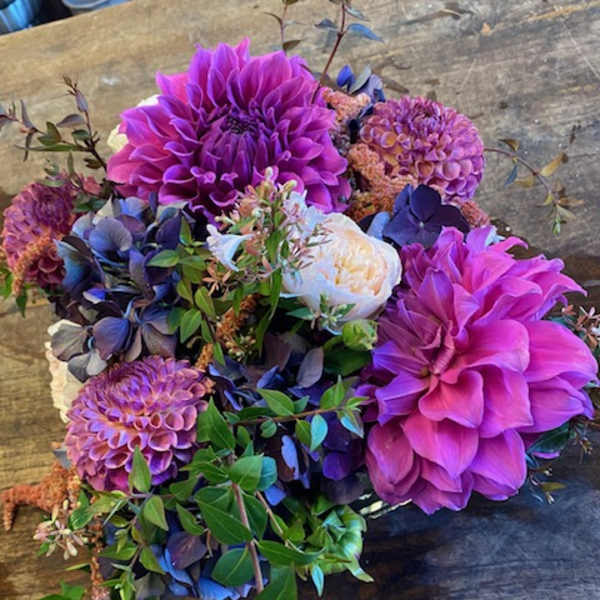 Bouquet of purple dahlias and blue hydrangeas with white blooms