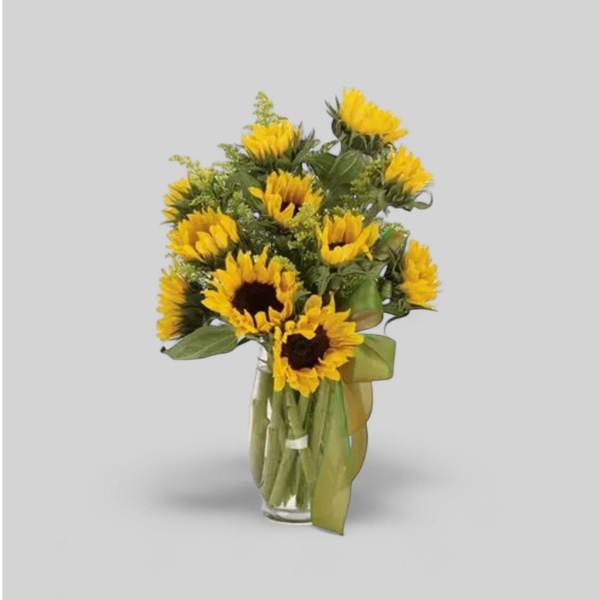 Bouquet of yellow sunflowers in a clear glass vase