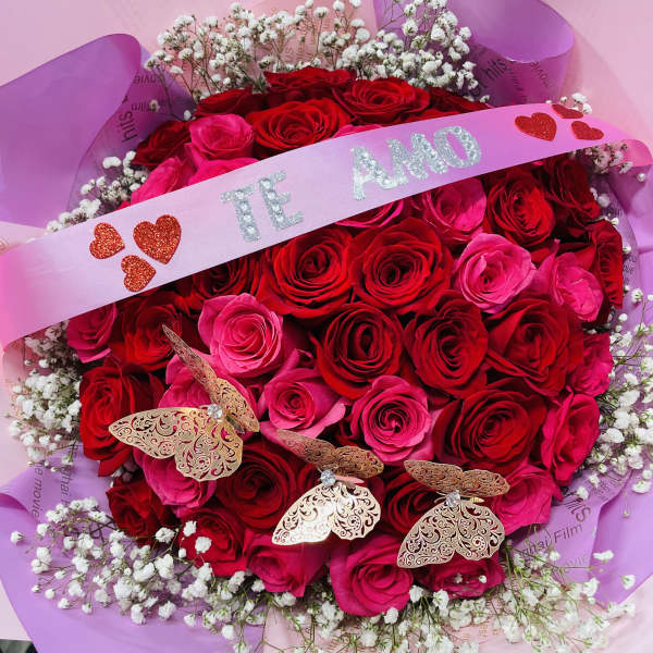 Bouquet of red and pink roses with baby's breath and a pink ribbon
