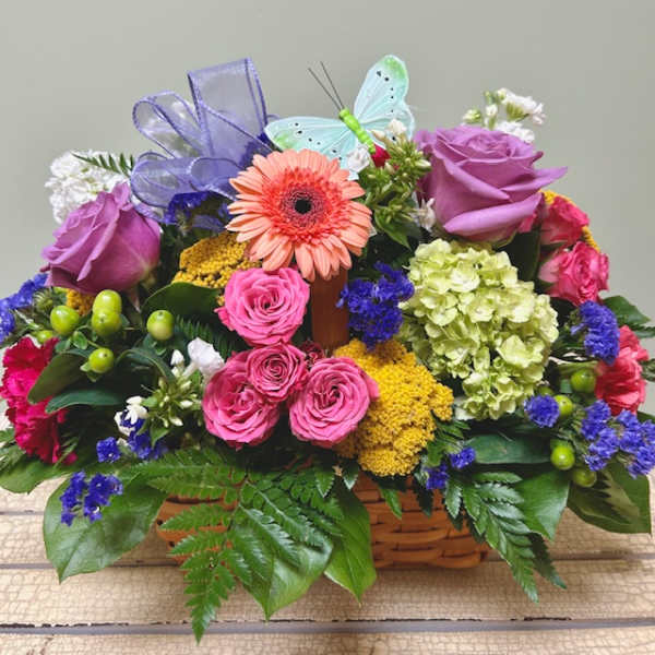 Colorful flower basket with roses, gerbera daisy, and ribbon butterfly