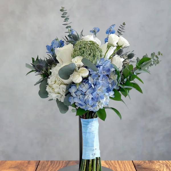 Blue and white bouquet with hydrangeas and roses on a stand