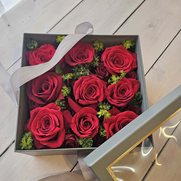 Box of red roses with a ribbon-tied lid