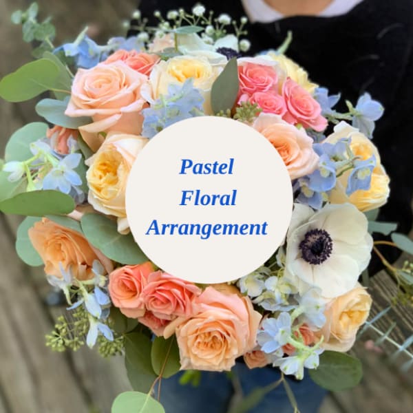 Pastel bouquet of roses and anemone flowers with blue accents