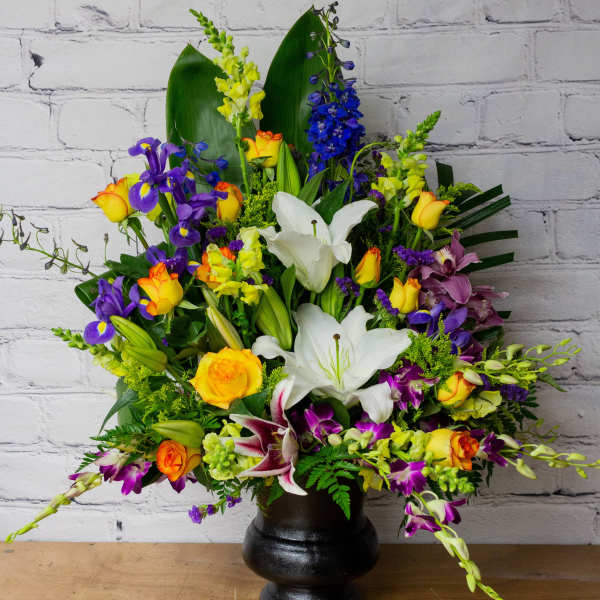 Colorful mixed flower arrangement in a black vase