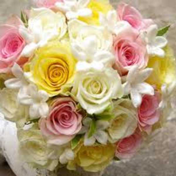 Bouquet of pink, yellow, and white roses with white blossoms