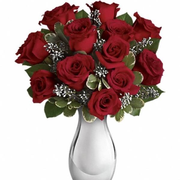 Red roses arranged in a silver vase
