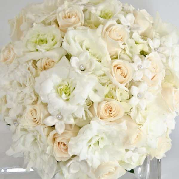 Cream and white bridal bouquet with roses and orchids