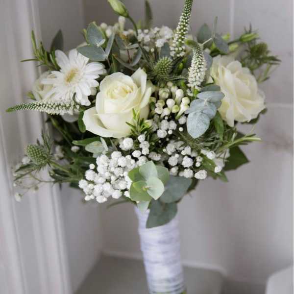 White rose bouquet with baby’s breath and eucalyptus wrapped in white ribbon