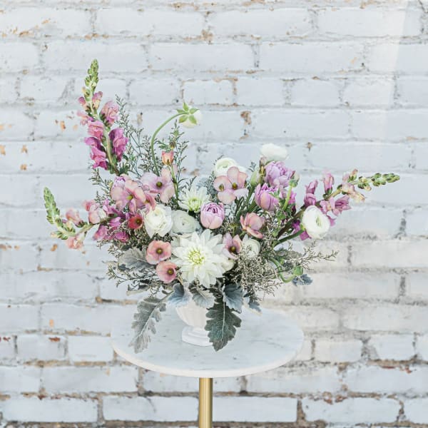 Pink and white floral arrangement in a white vase