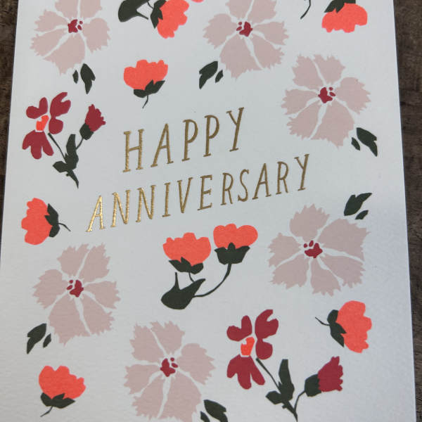 Happy anniversary greeting card with pink and red floral illustrations and gold lettering