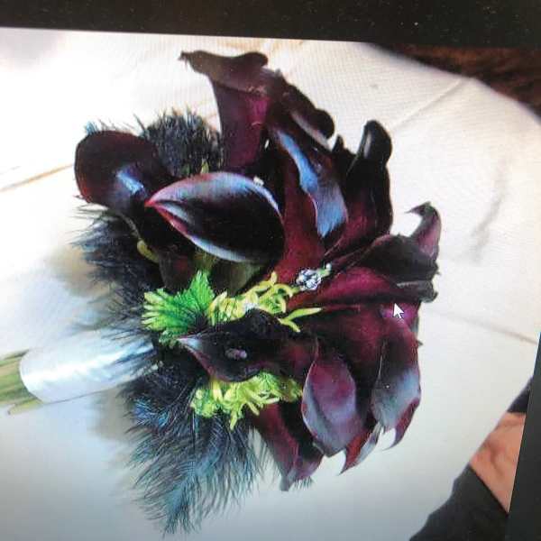 Dark burgundy calla lily bouquet with green accents