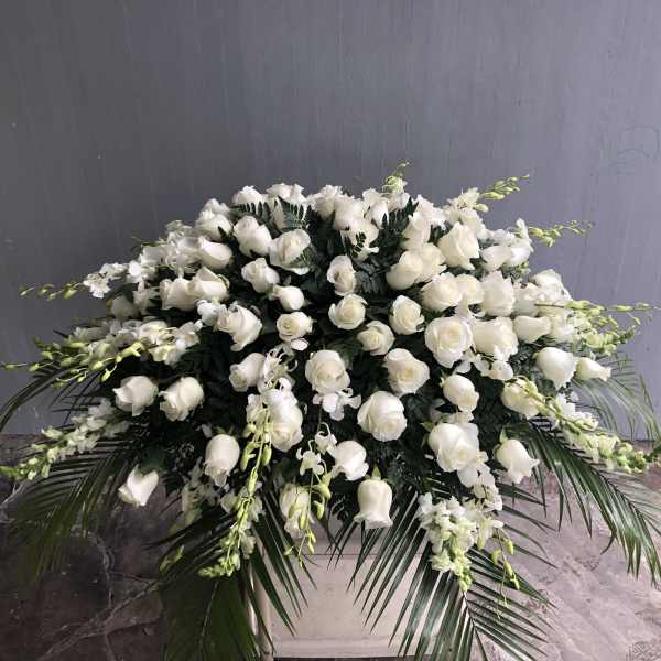 Large white floral arrangement in a white container