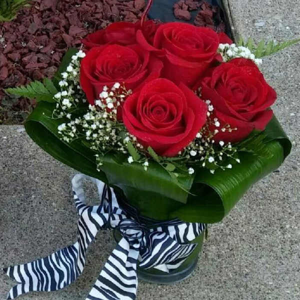 Bouquet of red roses with baby's breath and a striped ribbon