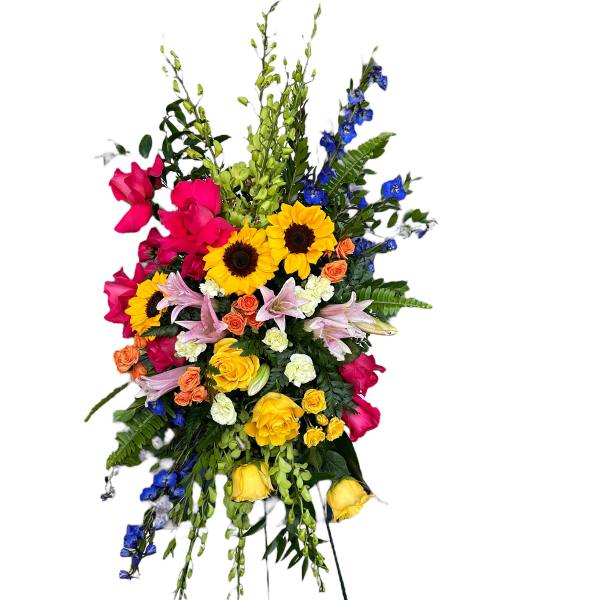 Tall standing floral spray with sunflowers, roses, lilies, and blue accents