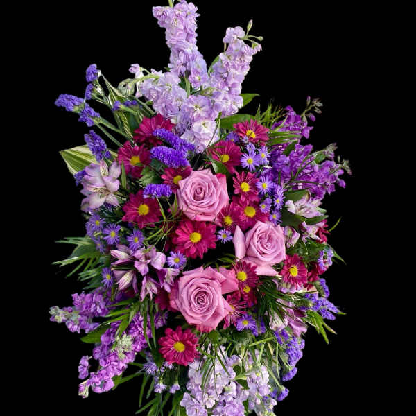 Pink roses and purple mixed flowers in a cascading bouquet