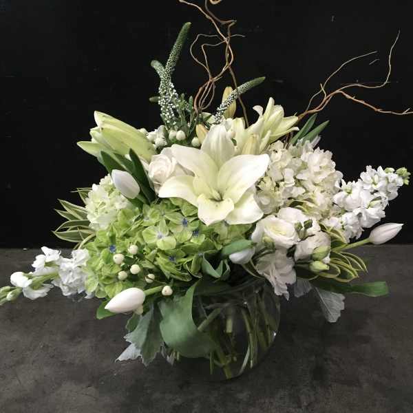 White lily and hydrangea arrangement in a glass vase