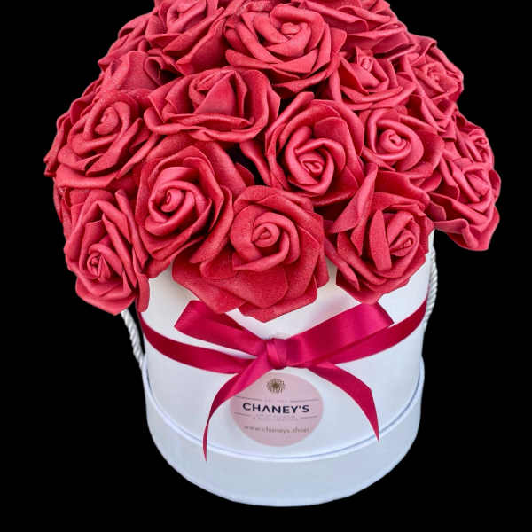Pink rose bouquet in a white round box with a ribbon