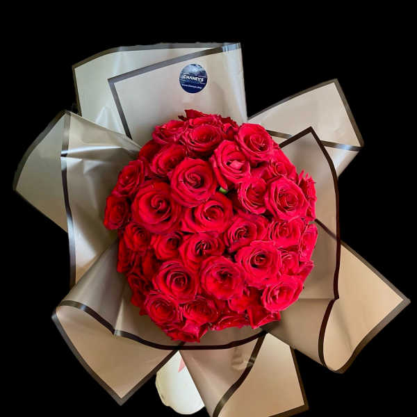 Bouquet of red roses wrapped in beige paper