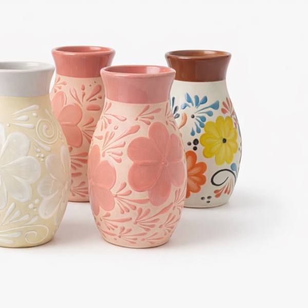 Five decorative ceramic vases with floral patterns in assorted colors