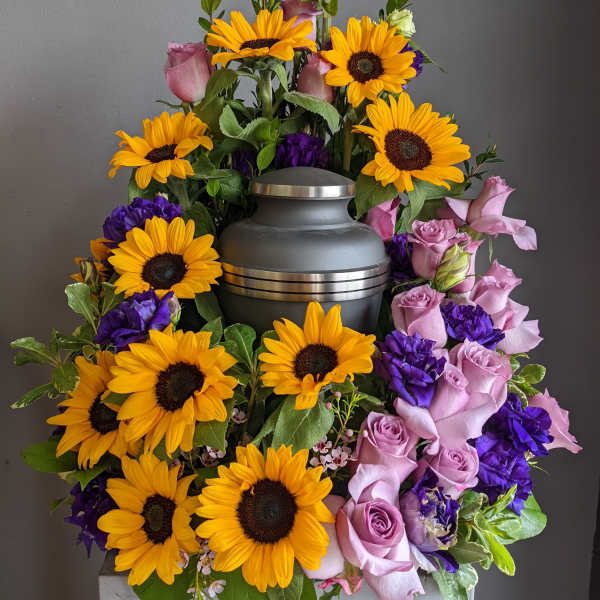 Sunflower and pink rose funeral urn arrangement